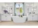 Spa-like bathroom with a freestanding tub, dual vanities, and natural light, exuding relaxation at 4754 Manning Ct, Sarasota, FL 34240