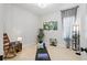 A versatile flex room with a yoga mat, rocking chair, and tranquil decor at 4754 Manning Ct, Sarasota, FL 34240
