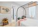 Bright bedroom with wood floors, canopy bed, and doorway view to the hallway at 4754 Manning Ct, Sarasota, FL 34240