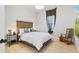Bright bedroom featuring a wooden bed frame, light wood floors, and a rocking chair at 4754 Manning Ct, Sarasota, FL 34240