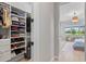 Well-organized closet space featuring shelving and hanging storage in a serene bedroom at 4754 Manning Ct, Sarasota, FL 34240
