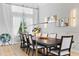 Open concept dining room features sleek, modern light fixture and large window for ample natural light at 4754 Manning Ct, Sarasota, FL 34240