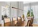 Bright dining room featuring a wood table, stylish chairs, decorative lighting, and large windows with plantation shutters at 4754 Manning Ct, Sarasota, FL 34240
