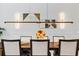 Close up of dining room highlights the lighting and decor in the room, adjacent to a wall of wainscotting at 4754 Manning Ct, Sarasota, FL 34240