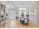 Bright, airy dining area showcases modern chandelier, stylish decor, and a glimpse of the front entrance at 4754 Manning Ct, Sarasota, FL 34240