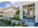 Well-maintained front of home boasts beautiful landscaping and a charming front door and covered porch at 4754 Manning Ct, Sarasota, FL 34240