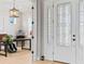 Elegant entryway showcasing a decorative glass front door, a view of a home office, and hardwood floors at 4754 Manning Ct, Sarasota, FL 34240