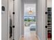 Bright hallway leading to a bedroom with wood floors and white trim and doors at 4754 Manning Ct, Sarasota, FL 34240