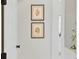 Bright hallway with charming floral wall art, showcasing the home's inviting and aesthetic appeal at 4754 Manning Ct, Sarasota, FL 34240