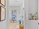 Hallway with light wood floors leads to a serene bathroom and cozy bedroom at 4754 Manning Ct, Sarasota, FL 34240