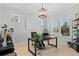 Well-lit home office with neutral walls, plantation shutters, a modern desk, and decorative touches at 4754 Manning Ct, Sarasota, FL 34240