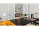 Home office showcasing a view to the dining room, modern light fixtures, and wood-look tile flooring at 4754 Manning Ct, Sarasota, FL 34240