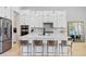 Modern kitchen with white cabinets, stainless steel appliances, and a large island with seating at 4754 Manning Ct, Sarasota, FL 34240