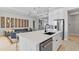 Modern kitchen with a spacious white quartz island, stainless steel appliances, and sleek pendant lighting at 4754 Manning Ct, Sarasota, FL 34240