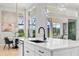 Kitchen island with sink, black faucet, and modern pendant lighting at 4754 Manning Ct, Sarasota, FL 34240