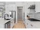 Modern kitchen with white cabinets, stainless steel appliances, and a functional layout at 4754 Manning Ct, Sarasota, FL 34240