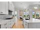 A bright kitchen features white cabinets, quartz countertops, an island, and stainless steel appliances at 4754 Manning Ct, Sarasota, FL 34240