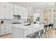 Contemporary kitchen featuring a large island with seating, stainless steel appliances, and a stylish backsplash at 4754 Manning Ct, Sarasota, FL 34240