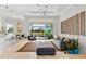 Open-concept living room with a view of the kitchen, dining area, and lanai overlooking the water at 4754 Manning Ct, Sarasota, FL 34240