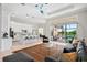 Bright, open floor plan living room showcasing a water view, adjacent kitchen, and decorative light fixtures at 4754 Manning Ct, Sarasota, FL 34240