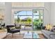 Living room showcasing water view from lanai, grey sectional sofa, and decorative light fixture at 4754 Manning Ct, Sarasota, FL 34240
