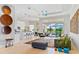 Open-concept living room with a view of the kitchen, dining area, and lanai overlooking the water at 4754 Manning Ct, Sarasota, FL 34240
