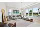 Cozy living room with large sectional couch, area rug, and scenic pond view at 4754 Manning Ct, Sarasota, FL 34240