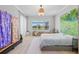 Bright and airy main bedroom featuring large windows, light wood floors, and an accent wall hanging at 4754 Manning Ct, Sarasota, FL 34240