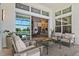 Covered patio with views of the pool and water, seamlessly blending indoor and outdoor living spaces at 4754 Manning Ct, Sarasota, FL 34240