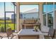 Outdoor dining area on screened-in patio, featuring a grill and views of the surrounding landscape at 4754 Manning Ct, Sarasota, FL 34240