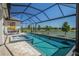 Stunning screened-in pool area overlooking a pond, with spa and plenty of room for outdoor entertaining at 4754 Manning Ct, Sarasota, FL 34240