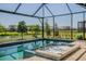 Relaxing screened-in pool and spa with serene water views, perfect for outdoor enjoyment at 4754 Manning Ct, Sarasota, FL 34240