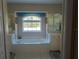 Bright bathroom with soaking tub, vanity, and large windows offers a luxurious escape at 4875 Hansard Ave, North Port, FL 34286