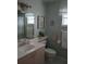 Well-lit bathroom with neutral color scheme, sink, toilet, tub and shower combo at 4875 Hansard Ave, North Port, FL 34286