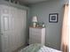 Comfortable bedroom with sliding door closet and a dresser with decor at 4875 Hansard Ave, North Port, FL 34286