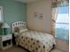 Bright bedroom with a cozy bed and view from the window at 4875 Hansard Ave, North Port, FL 34286
