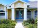 Inviting home entrance with double doors, decorative wreath and well-manicured garden at 4875 Hansard Ave, North Port, FL 34286