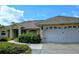 Inviting single-story home featuring attached two-car garage and manicured front yard at 4875 Hansard Ave, North Port, FL 34286
