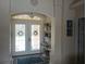 Bright foyer with decorative glass door, stylish decor, and elegant tile flooring welcomes you home at 4875 Hansard Ave, North Port, FL 34286
