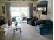 Cozy living room features plush seating, neutral tones, and sliding glass doors to a covered patio at 4875 Hansard Ave, North Port, FL 34286