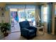 Cozy living room seating area with a view of the pool area and patio through sliding glass doors at 4875 Hansard Ave, North Port, FL 34286