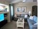 Comfortable living room with blue sofas, neutral walls, and decorative artwork at 4875 Hansard Ave, North Port, FL 34286