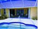 Relaxing poolside view under a covered lanai, offering comfortable seating and a tranquil atmosphere at 4875 Hansard Ave, North Port, FL 34286