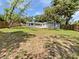 Large, grassy backyard enclosed by a wooden fence and shaded by mature trees at 5225 20Th N St, St Petersburg, FL 33714