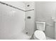 This renovated bathroom features a stand up shower with classic white subway tile and a grey accent border at 5225 20Th N St, St Petersburg, FL 33714