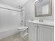 Clean bathroom with a shower-tub combo, white subway tiles, and a white vanity at 5225 20Th N St, St Petersburg, FL 33714