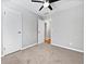 Spacious carpeted bedroom features a ceiling fan and large closet at 5225 20Th N St, St Petersburg, FL 33714