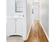 The hallway is filled with wood flooring and the bathroom vanity is easily accessible at 5225 20Th N St, St Petersburg, FL 33714