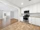 Modern kitchen with stainless steel appliances, white cabinets and eat in bar at 5225 20Th N St, St Petersburg, FL 33714