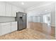 Kitchen featuring stainless steel refrigerator, white cabinets and a view to the living room at 5225 20Th N St, St Petersburg, FL 33714